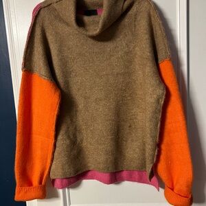 Gorgeous colorblock sweater. Pink in the back, tan front, orange sleeves